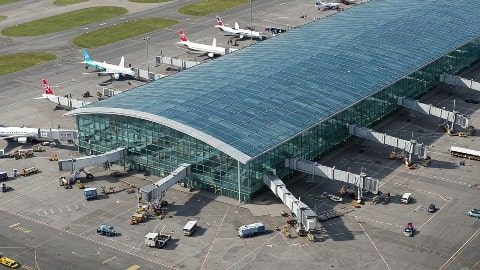 Modern Luton Airport terminal interior showing comfortable facilities, cafes, and passenger areas